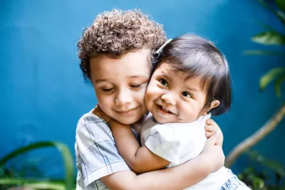 David Emanuel Setma Urzia (4 years old) hugs his sister Ana Elizabeth Setma Urzia (1 year old) in the garden of their home in Guatemala City. 
