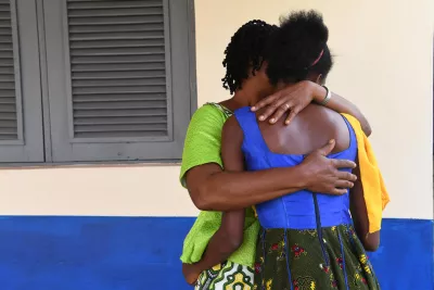 Mother gives her daughter a hug, Côte d'Ivoire.