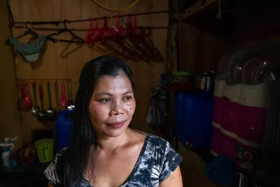 Ian Baro stands in the kitchen of her home