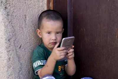 Young child holding mobile phone