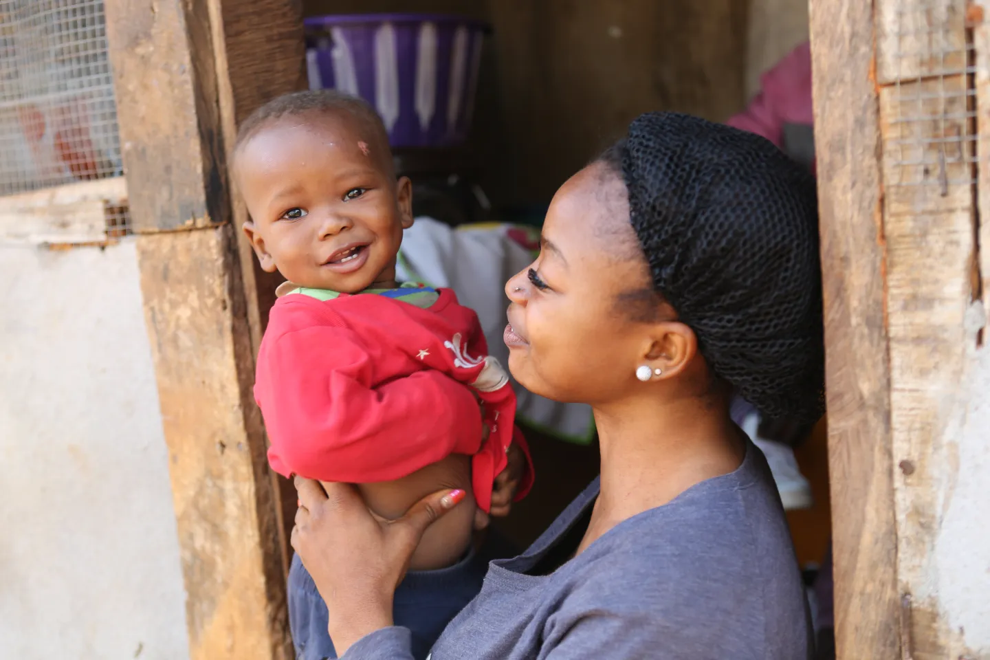 A woman smiles at her baby, Sierra Leone