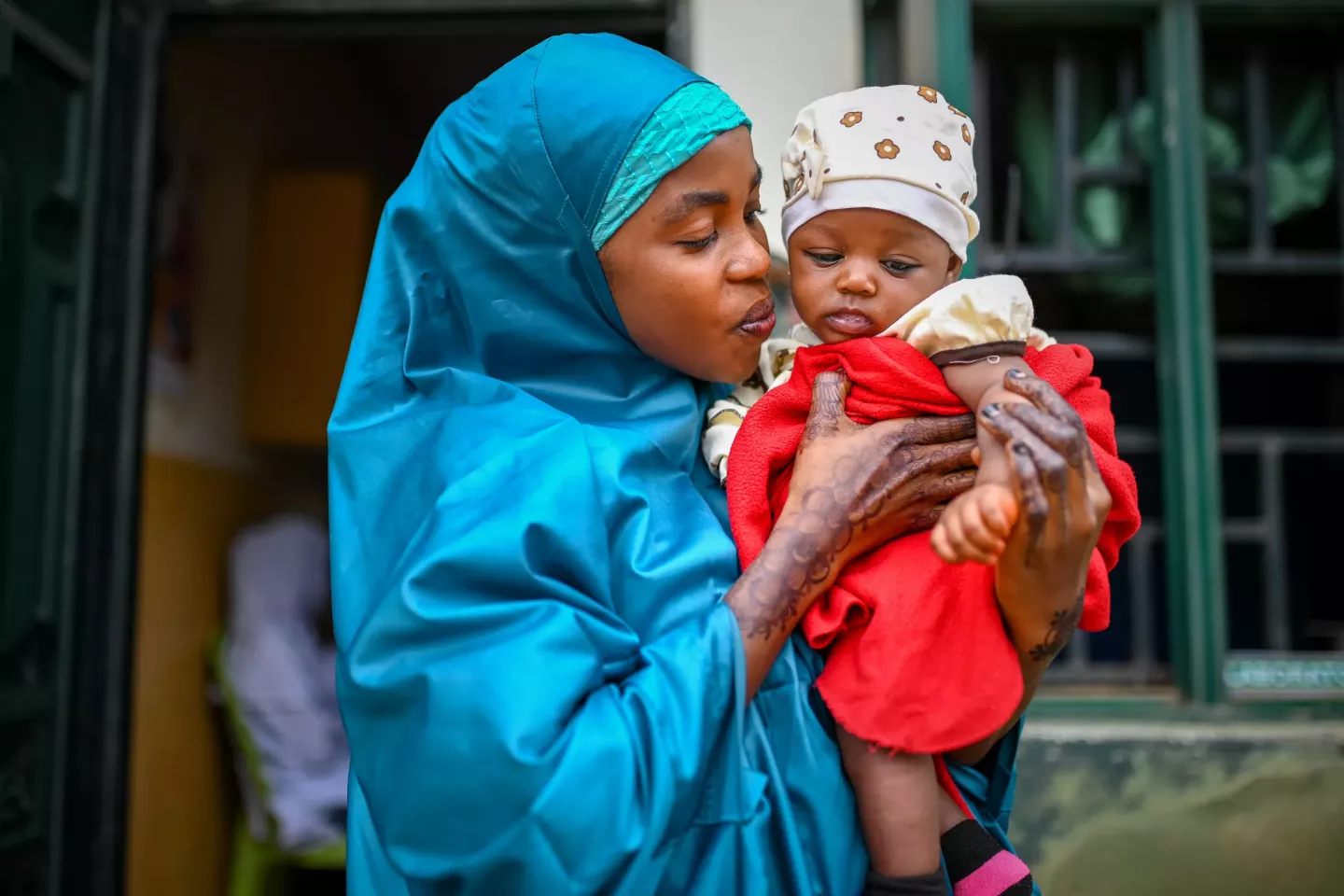 A mother of 21 years old holding her baby at a health care center