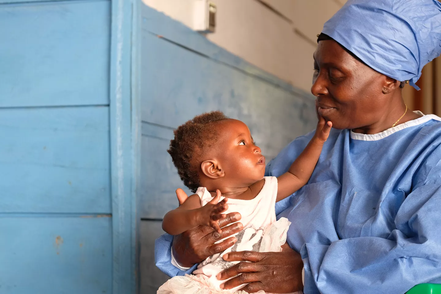 Democratic Republic of the Congo. An Ebola survivor who is now immune to the disease and working as a carer, holds a baby at a UNICEF-supported nursery.