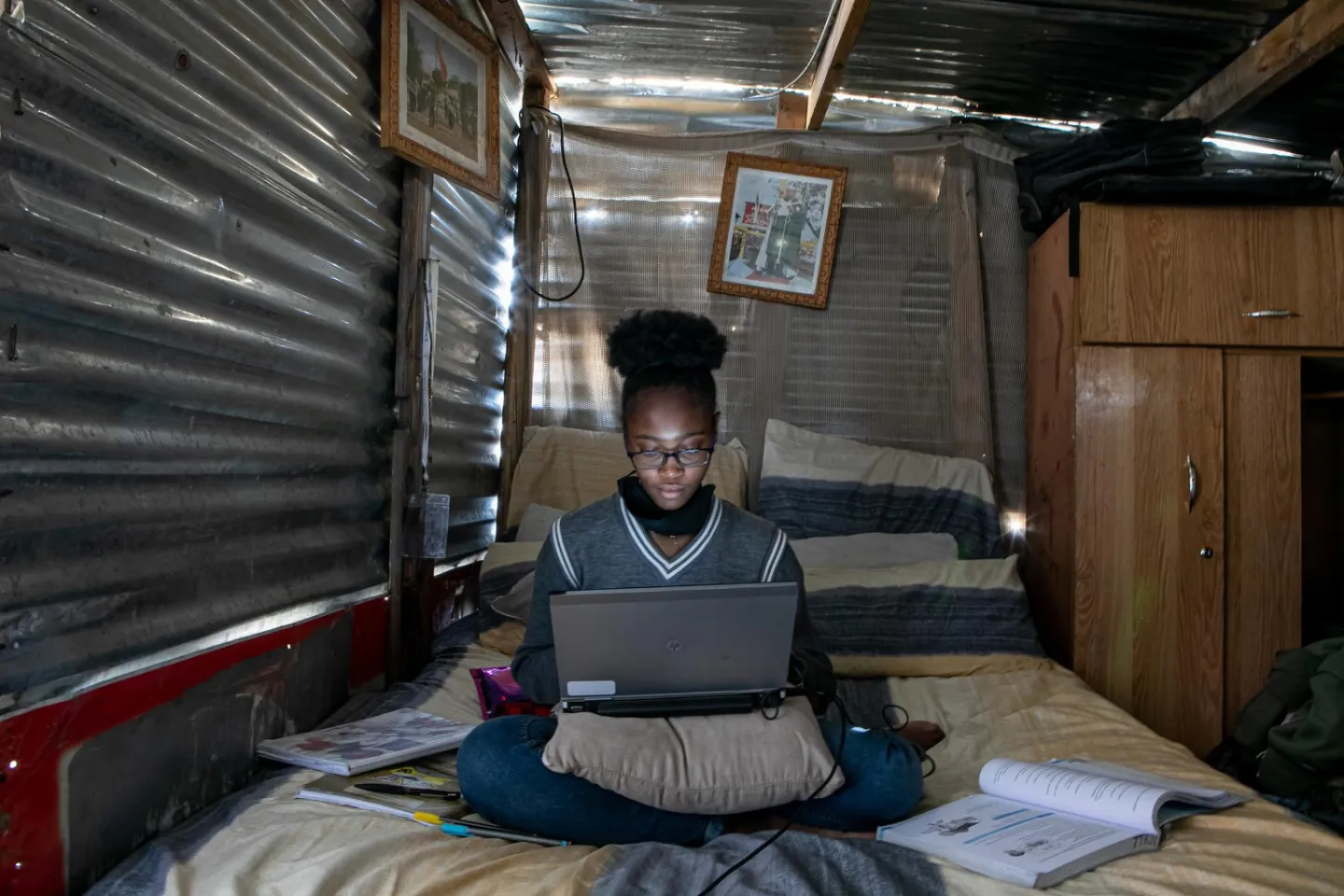 A young girl takes online classes and develops projects on her laptop, at home.