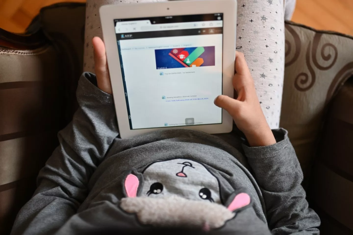 School girl using a tablet at home in Egypt