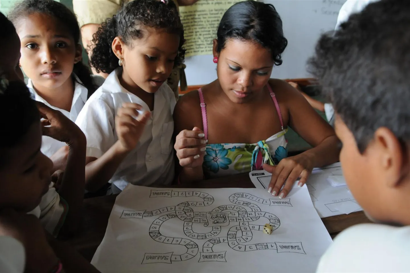 A girl plays a board game with her mother