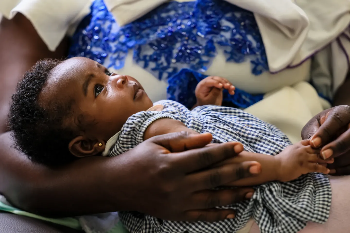 A mother holding her child during a breastfeeding and nutrition session.