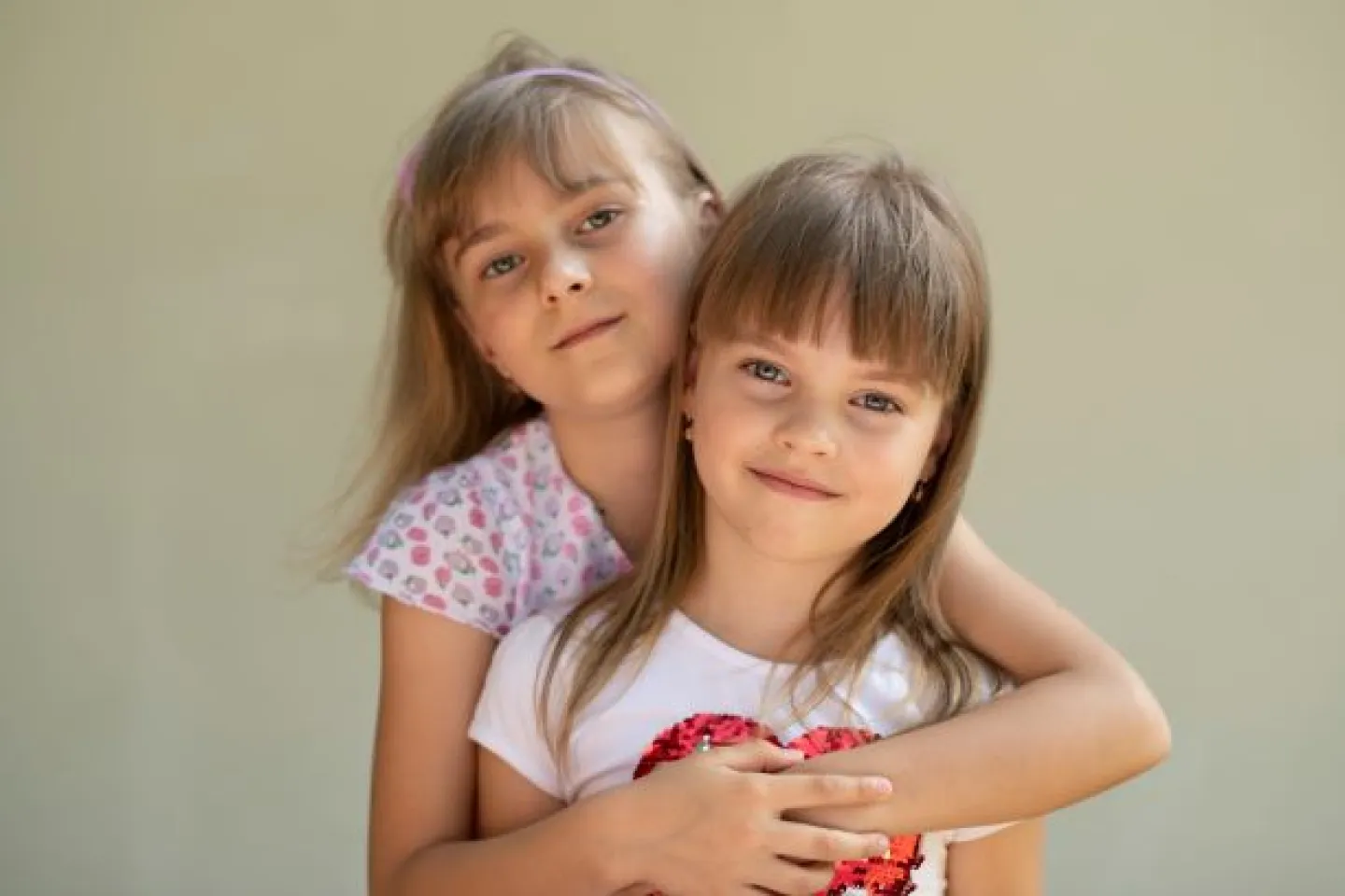 Two sisters pose for a photo