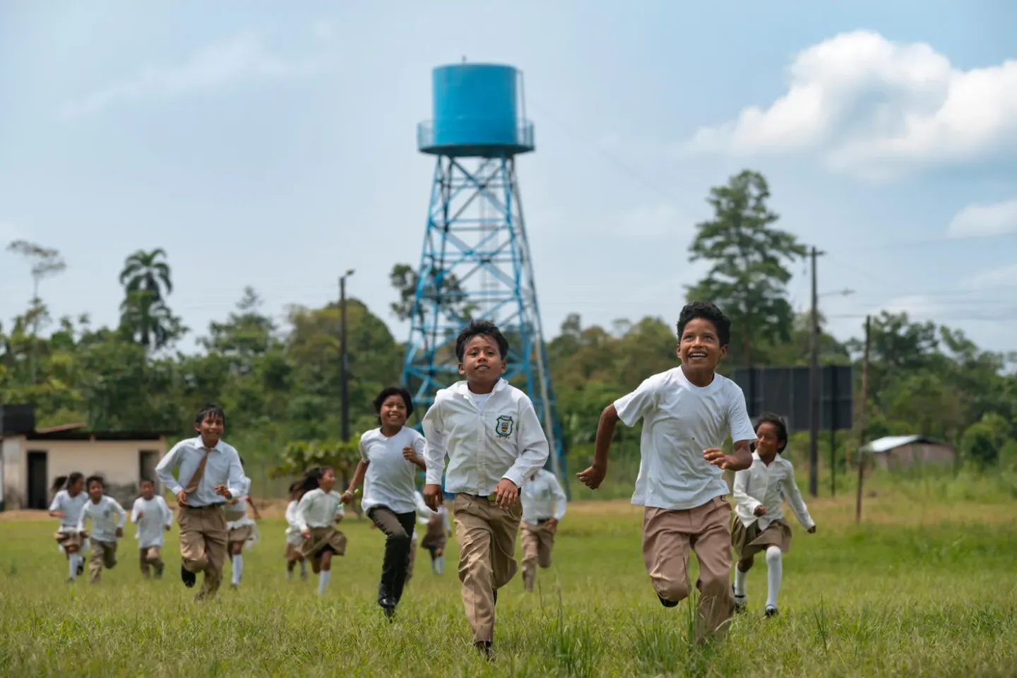 Young students running in the grass