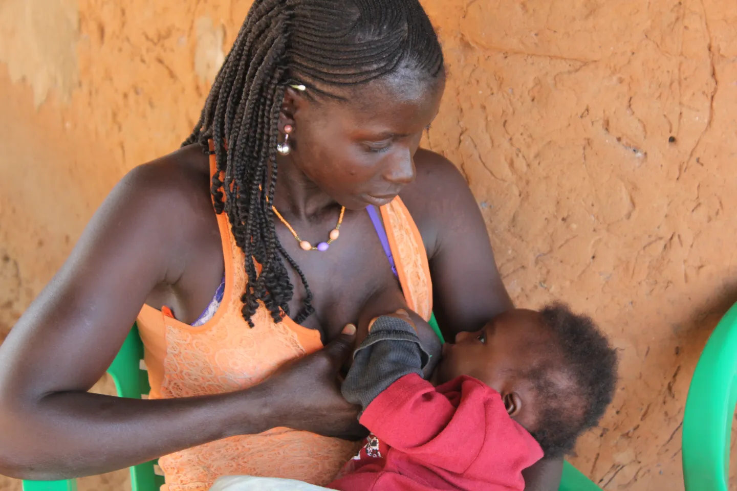 A woman breastfeeds her child, Guinea-Bissau