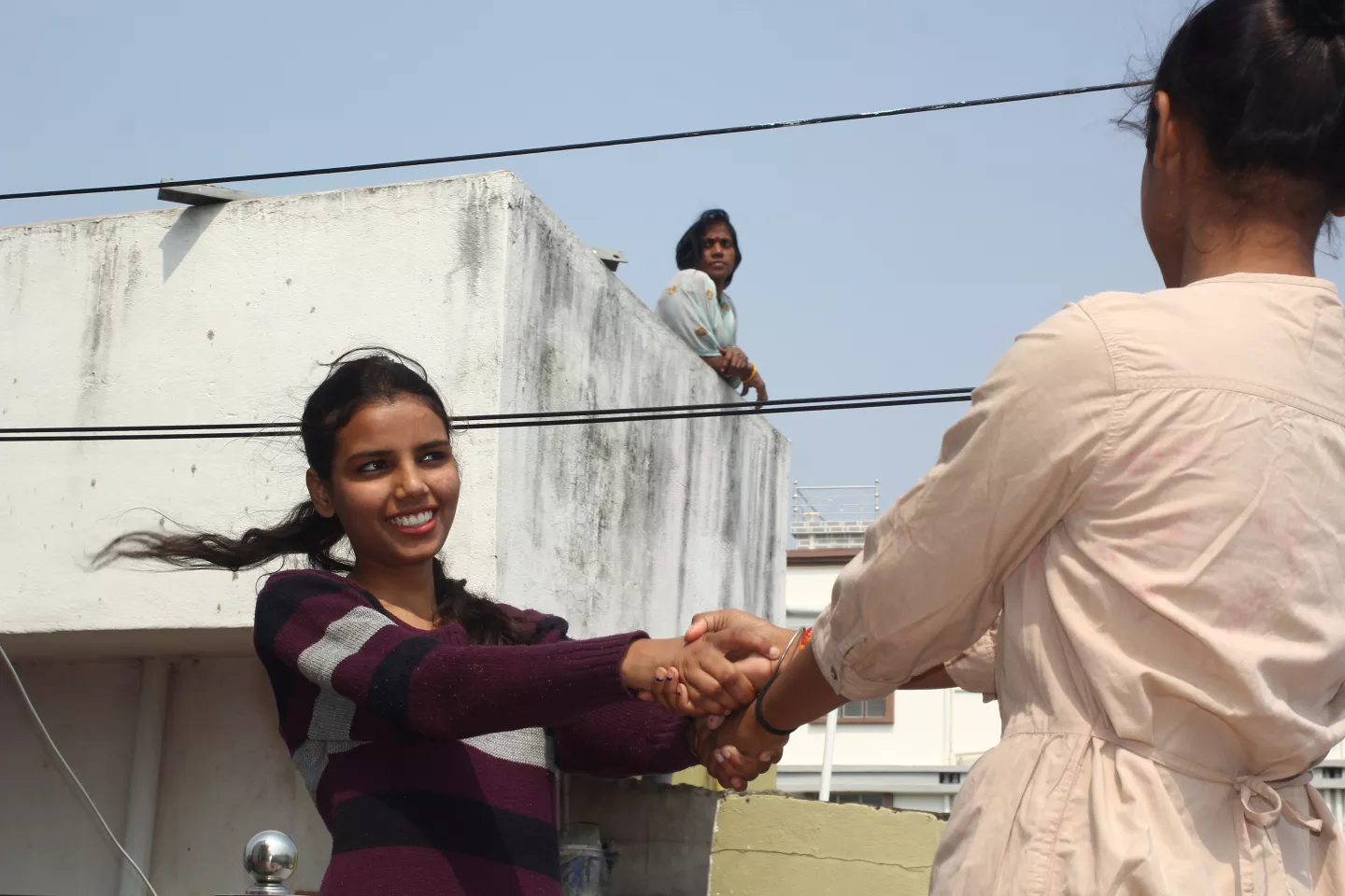 A girl playing with her sister in Bihar, India