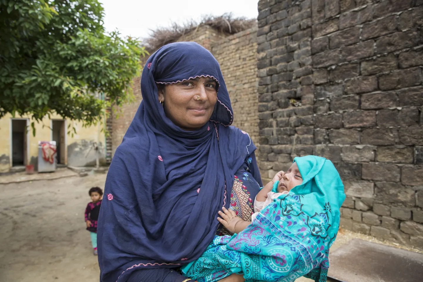 A mother holds her newborn baby, Pakistan