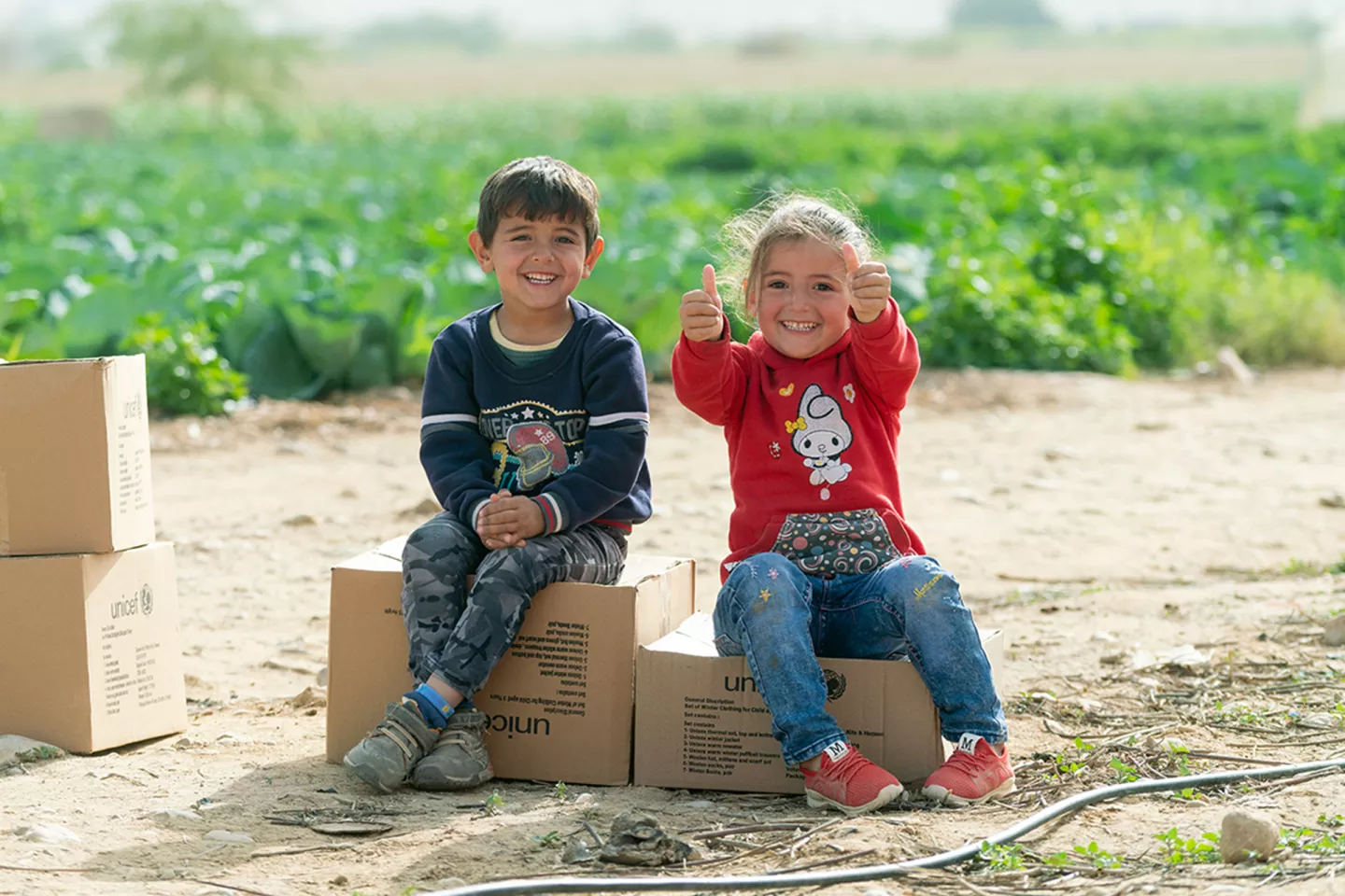 Young Syrian children, who came to Jordan with their family six years ago, received their winter clothing kits from UNICEF and its partner Mateen. 