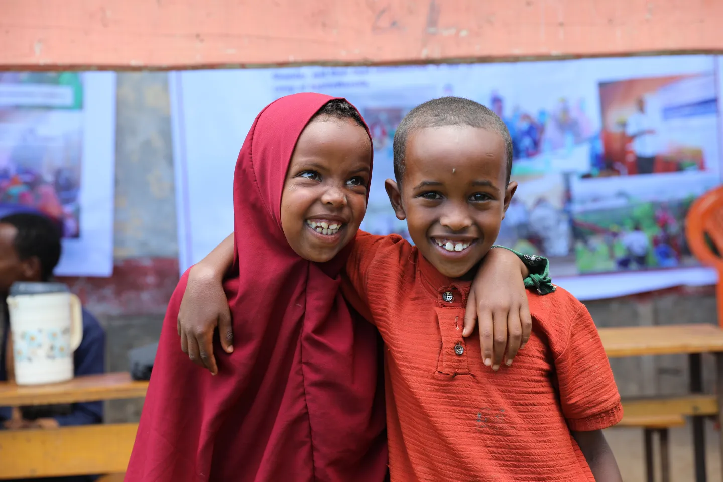 Two children pausing for the camera in the UNICEF-supported primary school and child-friendly space in Qoloji, Somali region.