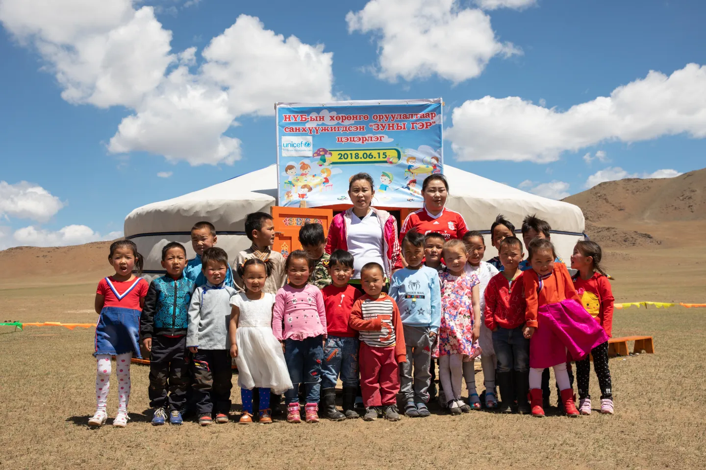 Young children and teachers, from a nomadic herder community, outside a newly opened mobile &lsquo;ger&rsquo; (traditional nomadic tent) kindergarten, in Bayankhongor Province, Mongolia.
