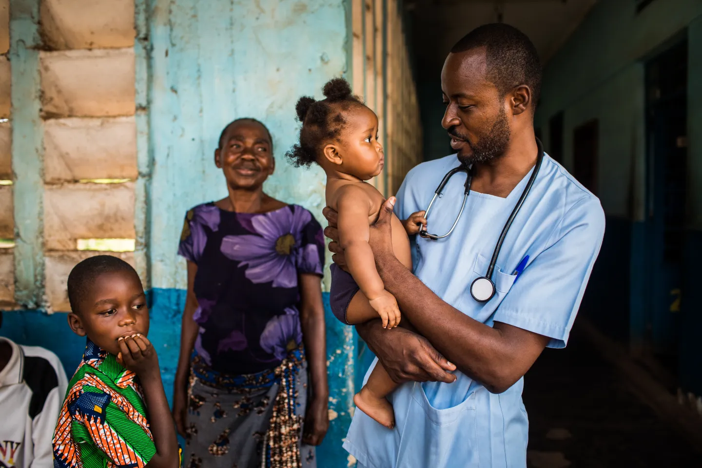A doctor holds a child in his arms in the Kasai region, Democratic Republic of the Congo (DRC)