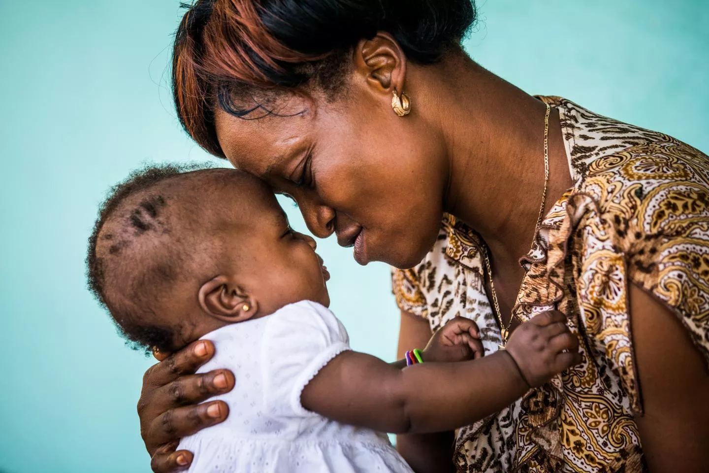 Une m&egrave;re porte son enfant dans ses bras. 