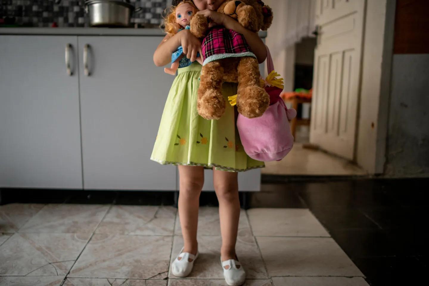 A young girl, who is the daughter of a survivor of domestic violence. When she was born, this violence extended to her.