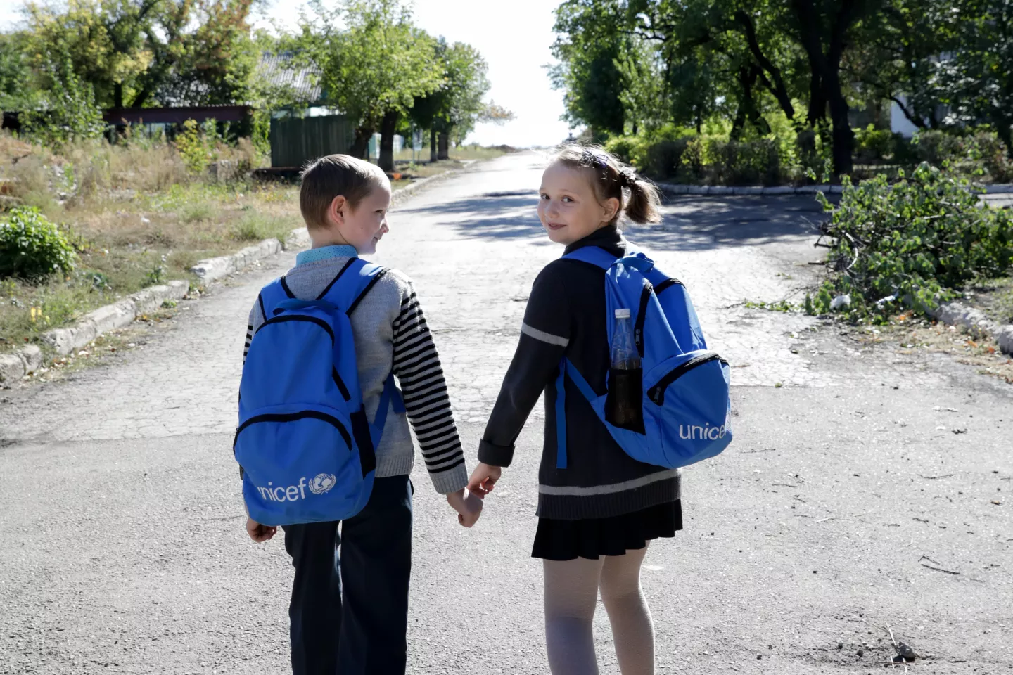 A boy and a girl walk down the road in Ukraine