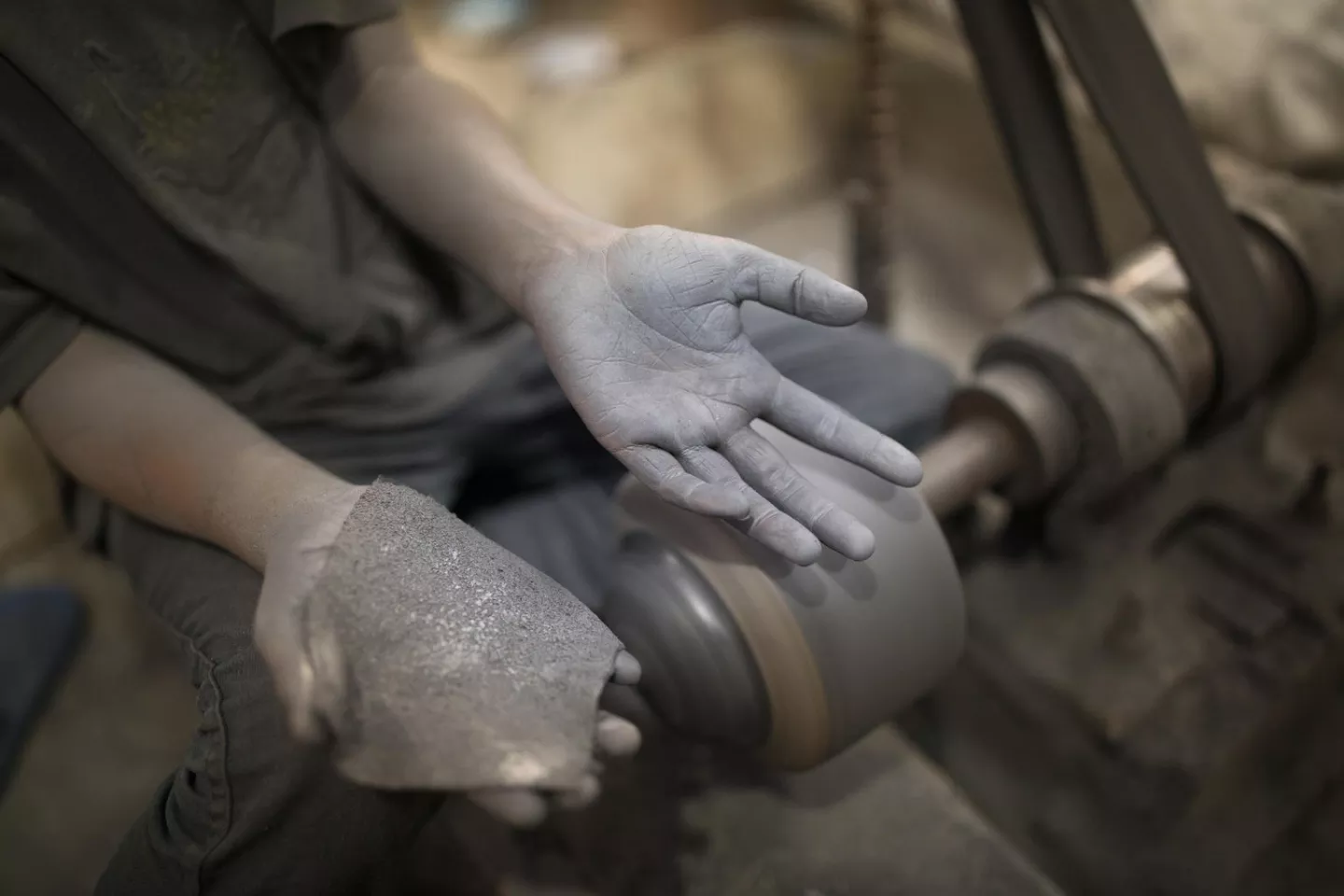 A ten-year-old boy subjected to child labour in Bangladesh shows his hands, dirty from work, in 2018.