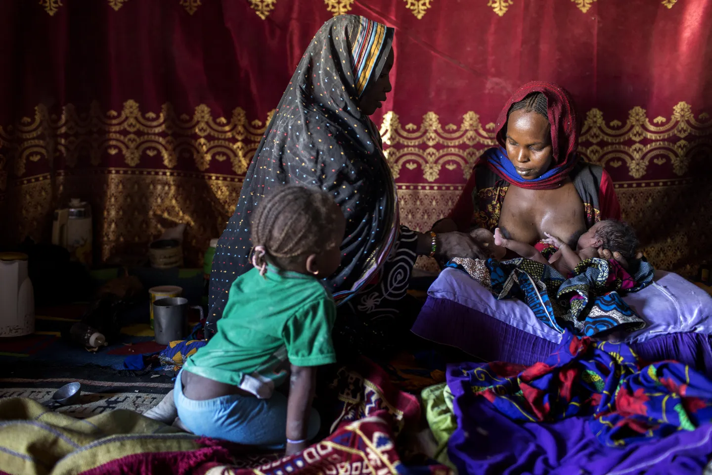 Bila Wodji Mahamat visiting a mother with newborn twin babies, as part of her community outreach. 