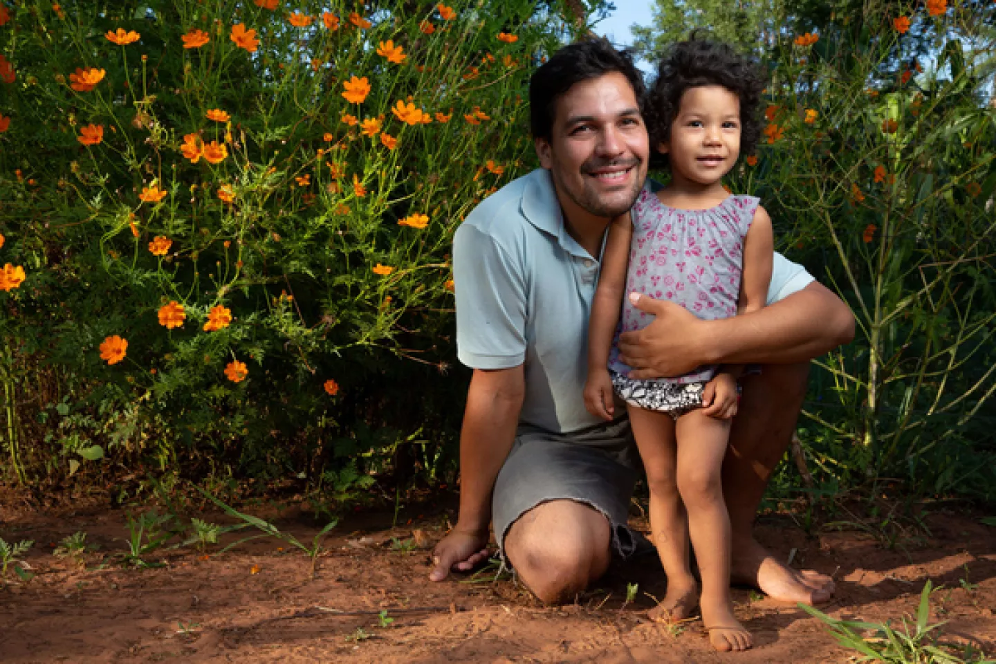 A father wraps his arm around his daughter, Paraguay