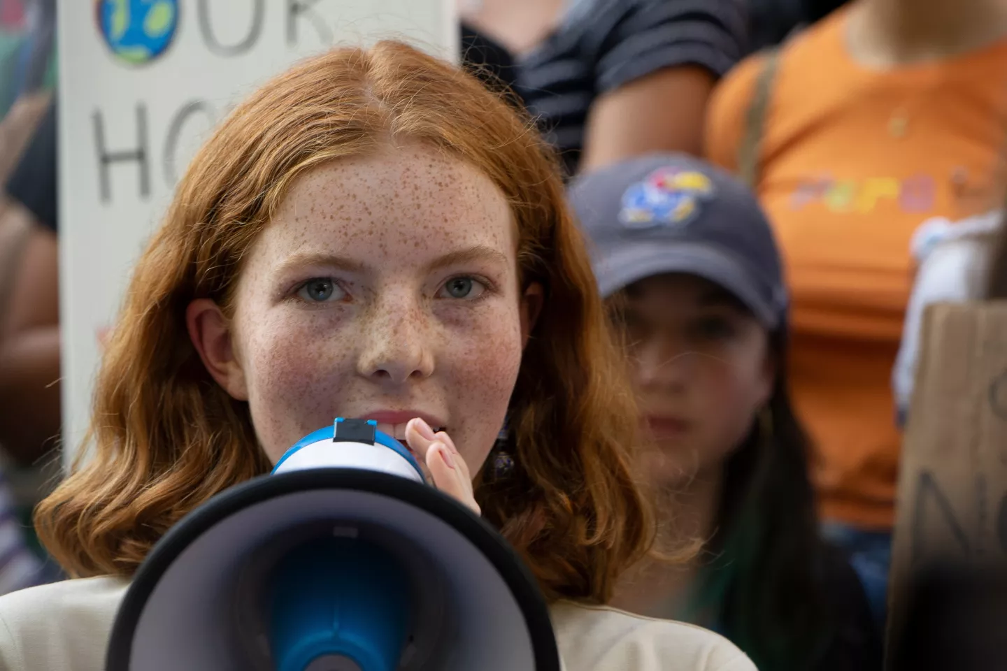 New York City: a girl speaks into a loud speaker at a climate action demonstration.