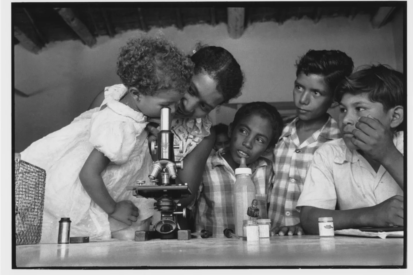 A girl looking through a microscope