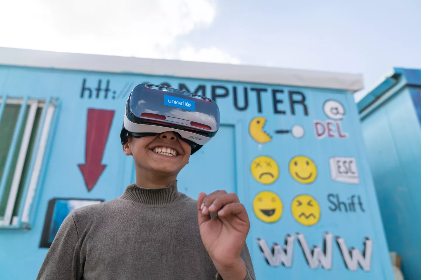 Mansoor,12, watches the virtual reality documentary &lsquo;Clouds over Sidra&rsquo; with a big grin, outside a UNICEF-supported Makani centre in the Za&rsquo;atari camp for Syrian refugees, in Mafraq Governorate, near the Syrian border.