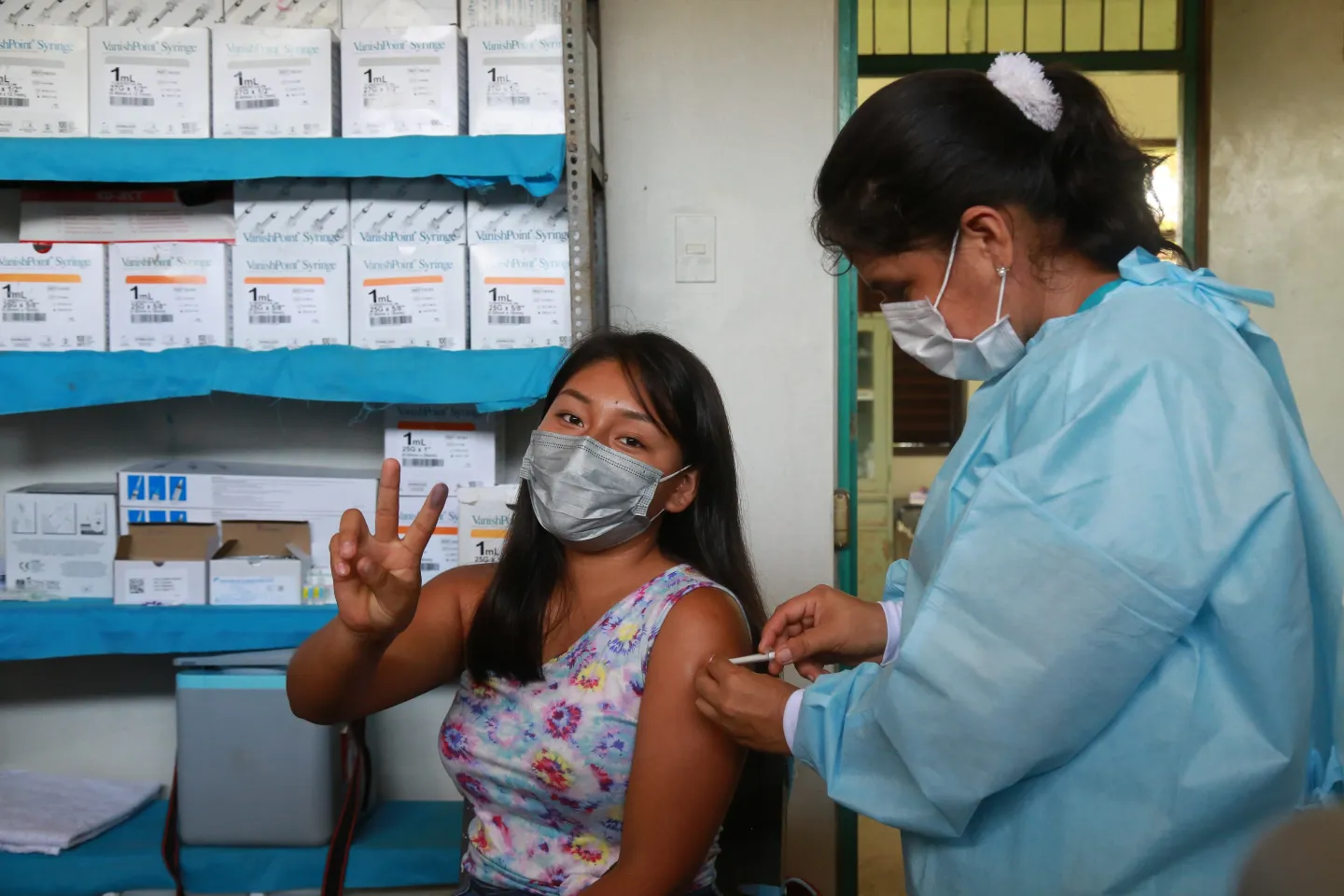 Peru. A woman receives a COVID-19 vaccine.