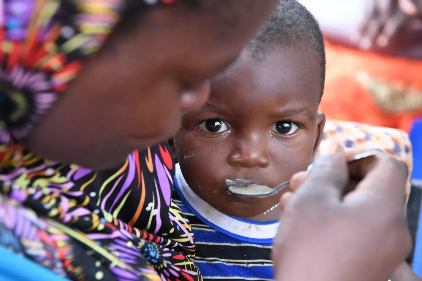 Burkina Faso. A woman feeds a child at a malnutrition screening session.