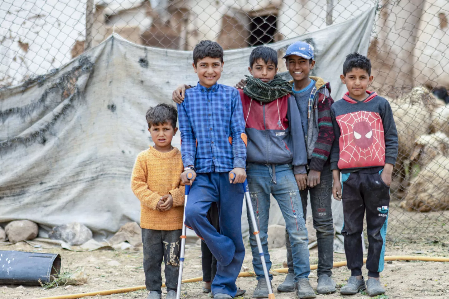 Four young boys standing together in rural Aleppo, Syria