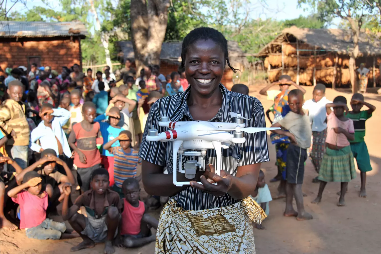 a young woman holding a drone