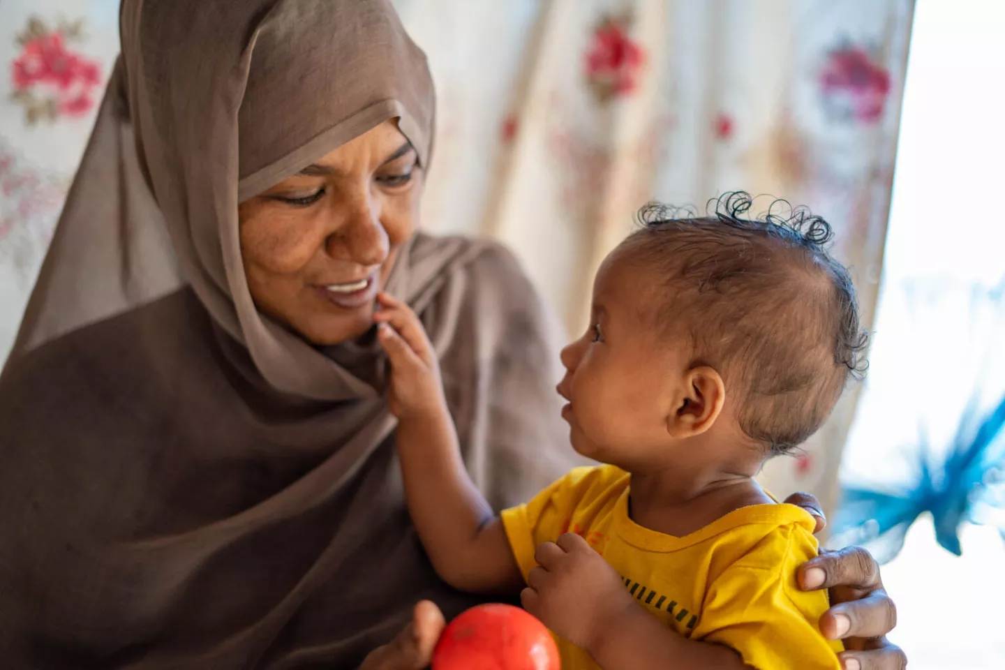 Sudan. A woman plays with her daughter at their home in Wager village in Kassala State, Sudan.