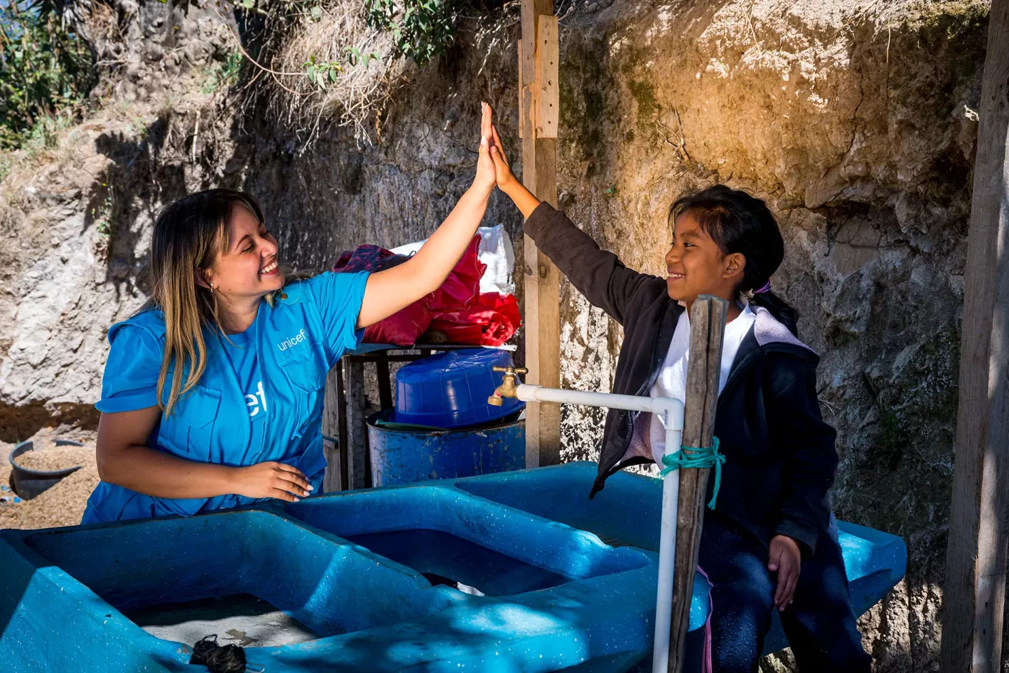 Michelle Casta&ntilde;eda (UNICEF) making high-five with Dina Perez (9) On March 30, 2023 in Solol&aacute; Guatemala,