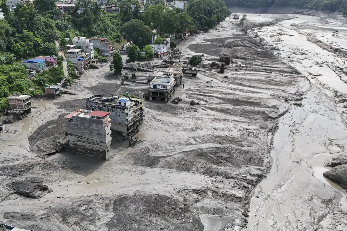 An aerial view of a settlement swept away in mud.