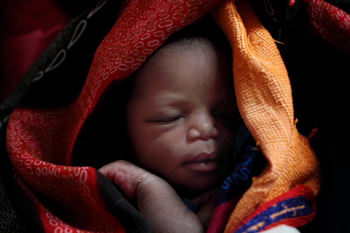 A newborn, wrapped in blankets, sleeps in Wau Hospital in the city of Wau, capital of Western Bahr al Ghazal State in Southern Sudan.