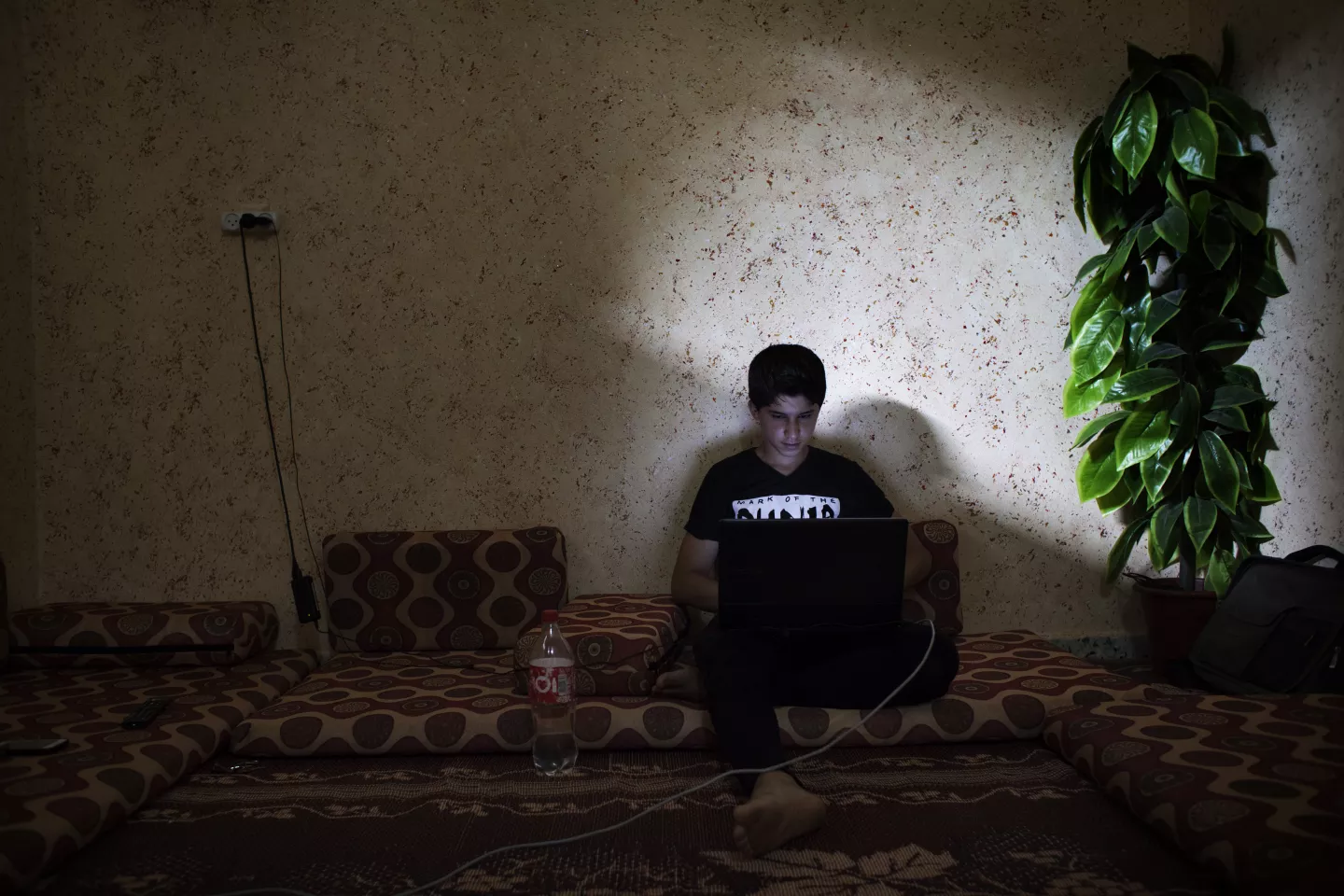 A boy works on his laptop