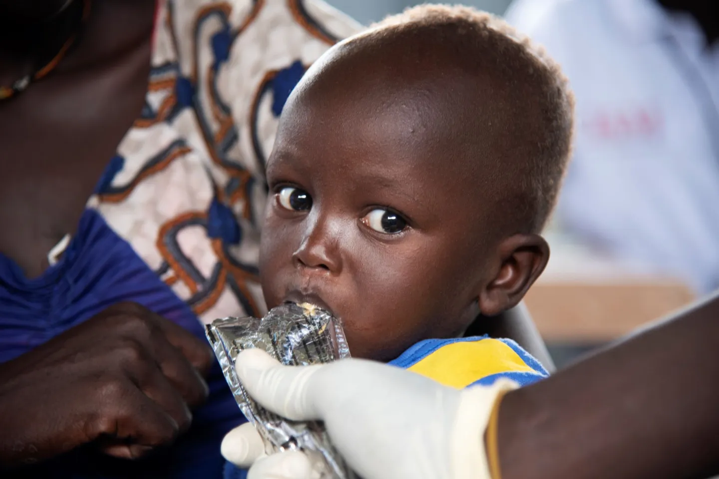 South Sudan. A woman holds her baby.