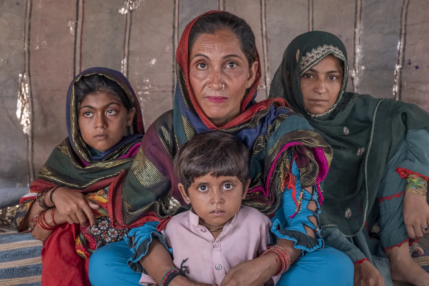 Rehana Bibi, 36, sitting inside a tent with her children (from left to right): Muskan, 8, Aisha, 3, and Ghazal, 14. The tent become family&rsquo;s temporary shelter after their house in Geokaloi Village, Sindh Province was flooded.