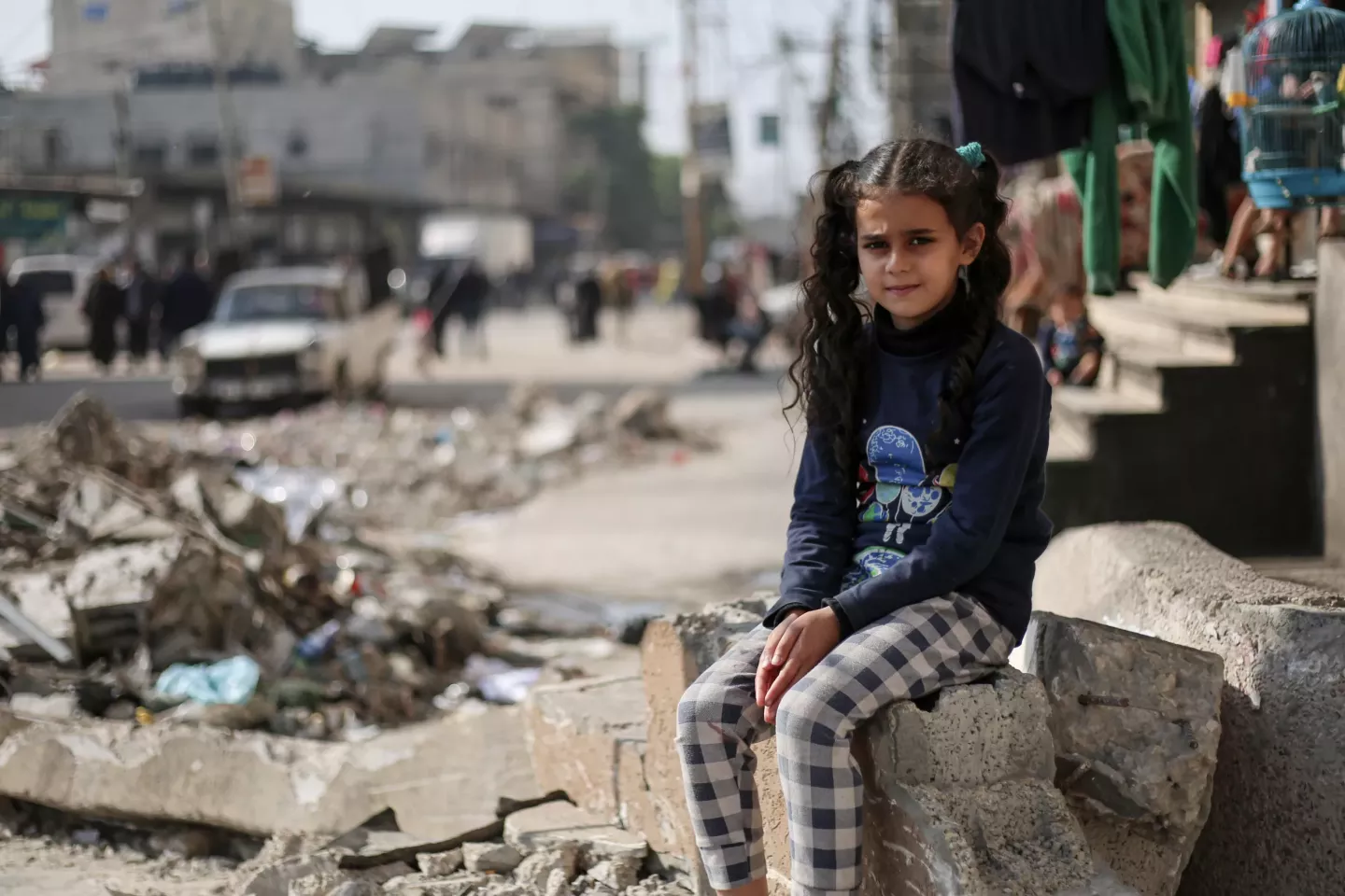 Gaza Strip. A girl sits amid the rubble of a destroyed building in the Gaza Strip.