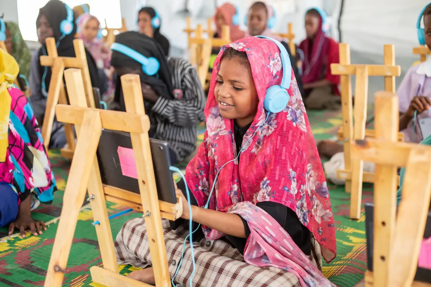 Sudan. Children attend an e-learning session at the UNICEF-supported Makana at a gathering point located in White Nile state.