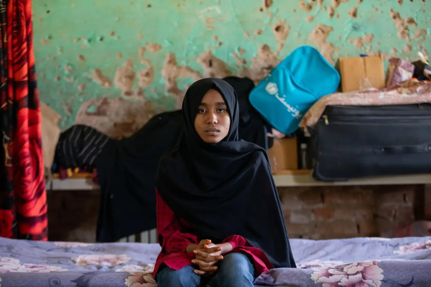 Sudan. A girl sits in an empty classroom that also doubles as her new home in Kassala.