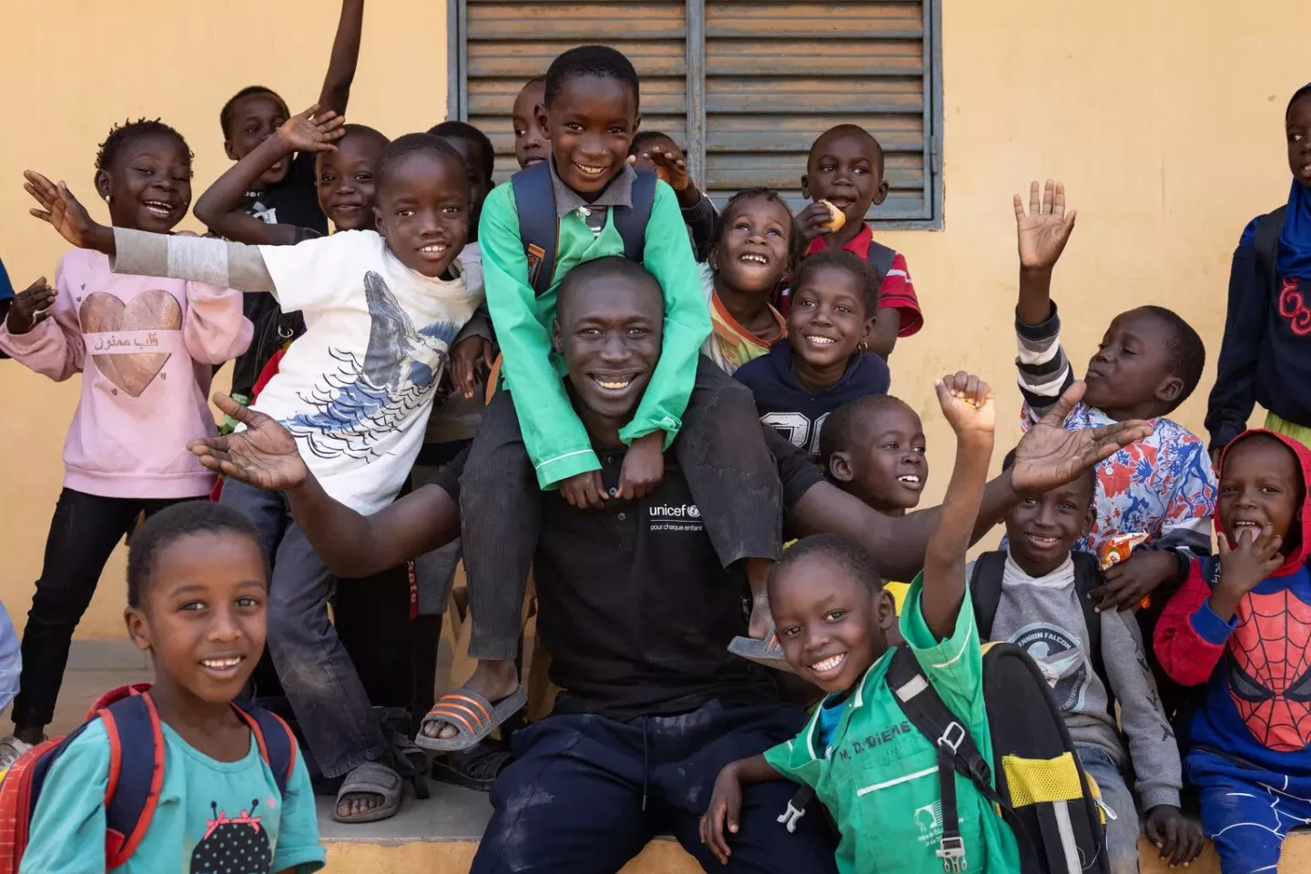 On 28 January 2025 in Senegal, Khaby Lame (wearing black shirt) poses with students while visiting a school in Ziguinchor, the city in which he was born.