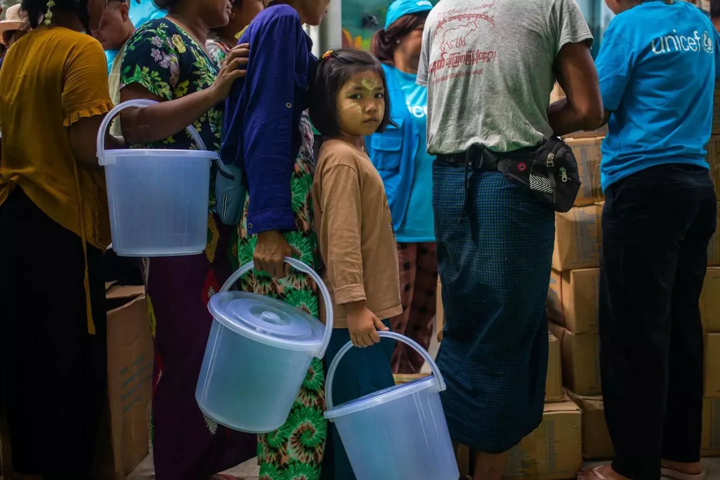 Myanmar. A girl queues for essential relief supplies during a distribution at a temporary camp in Mandalay Region.