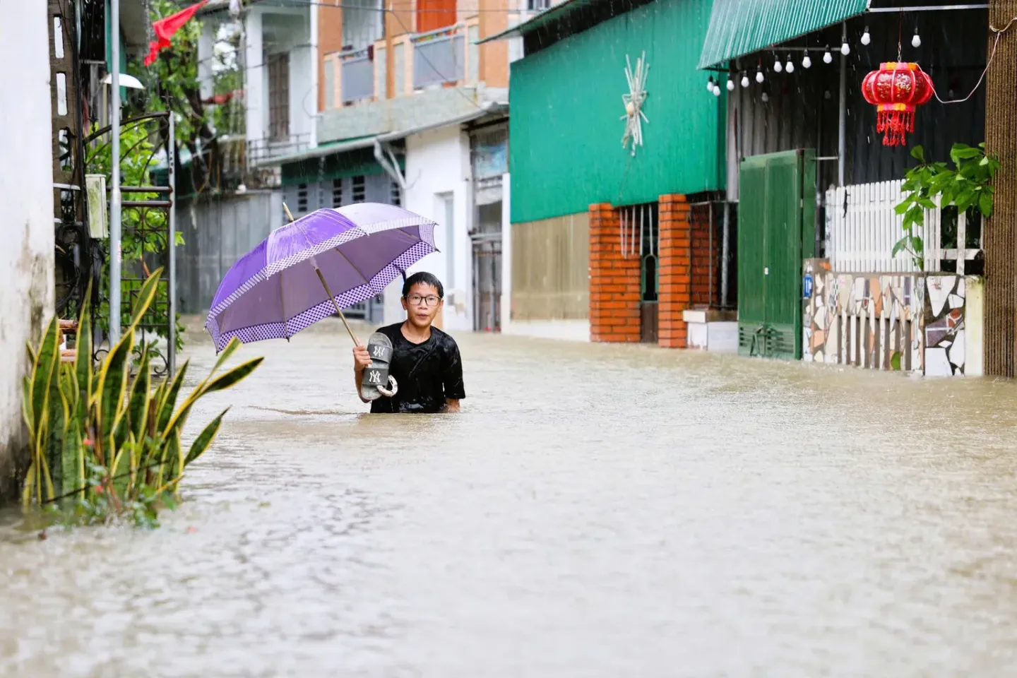 Vietnam. A boy stands in a flooded area in Vinh City, Vietnam, following Tropical Storm Bualoi.