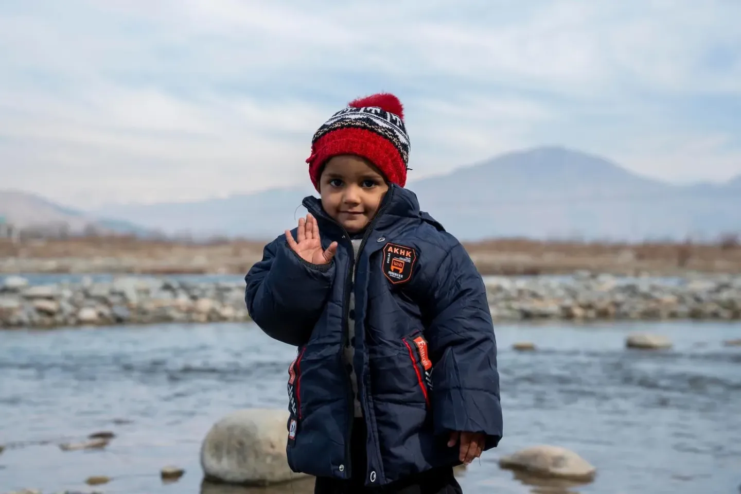 Pakistan. A girl smiles and waves at the camera in Mingora, Pakistan.