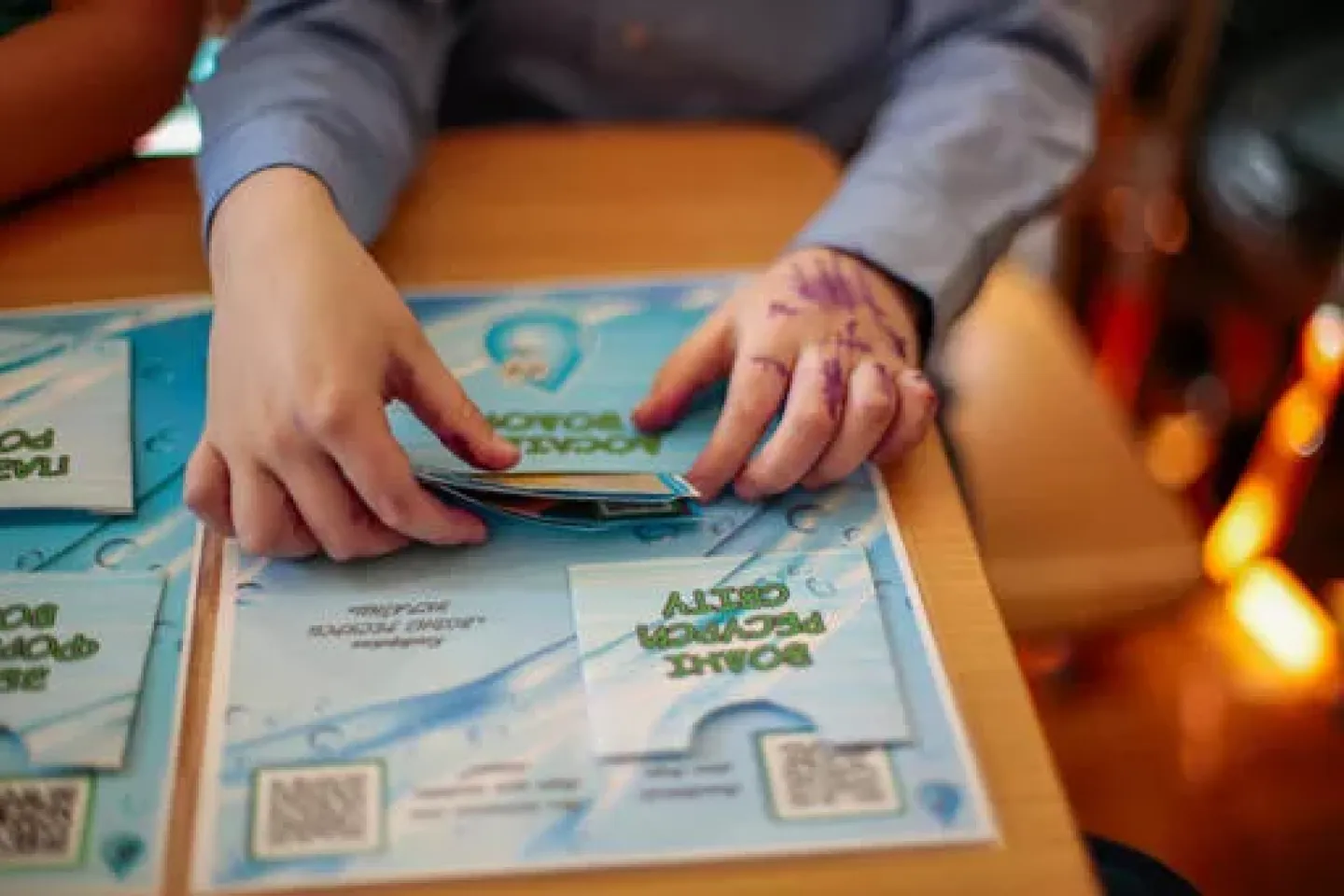 March 5, 2024, Lviv, Ukraine. Сlose-up of child's hands and educational materials about water conservation, provided by UNICEF.