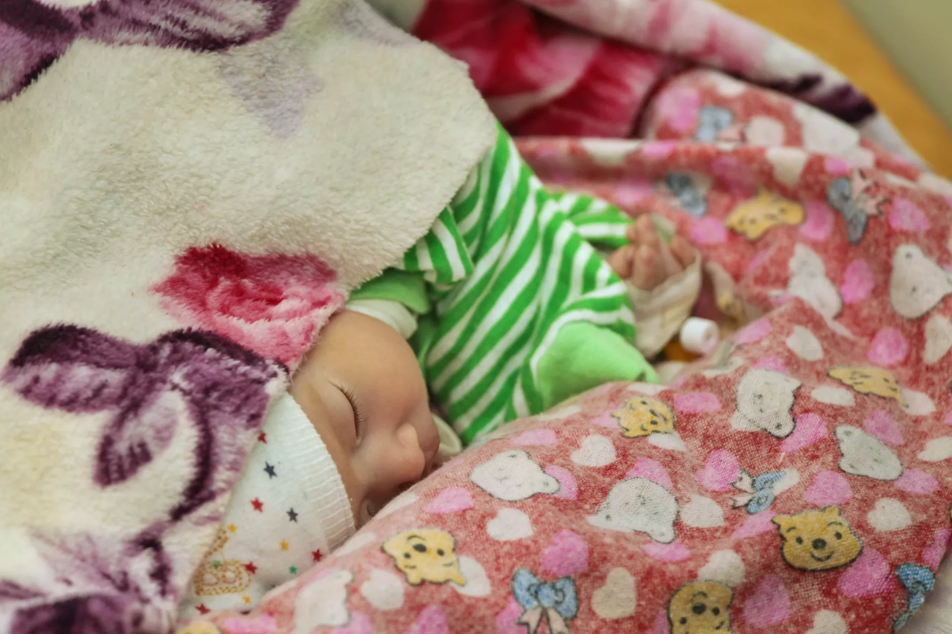 A baby asleep in a blanket