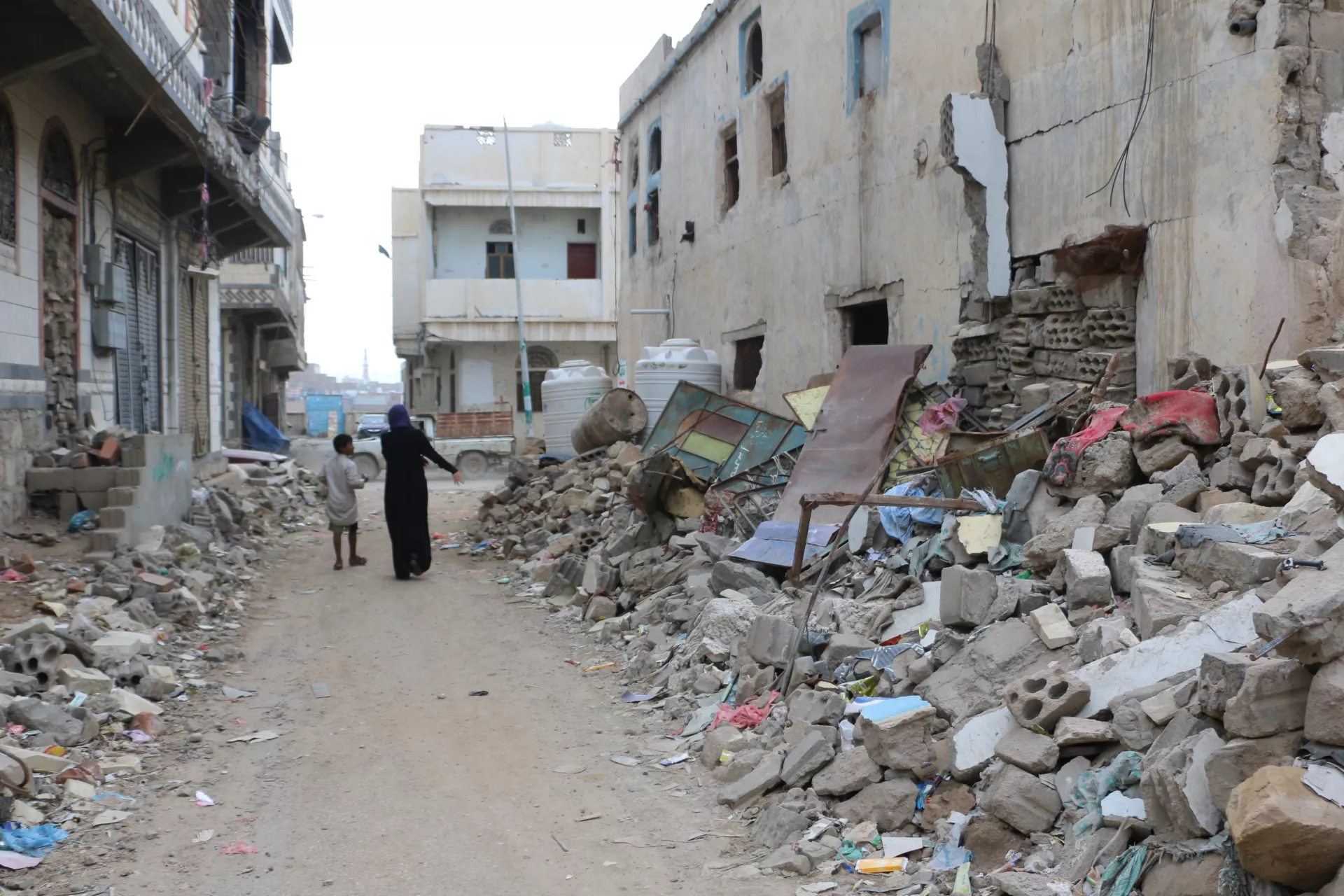 10-year-old Fahd walks past the destruction caused by the conflict.